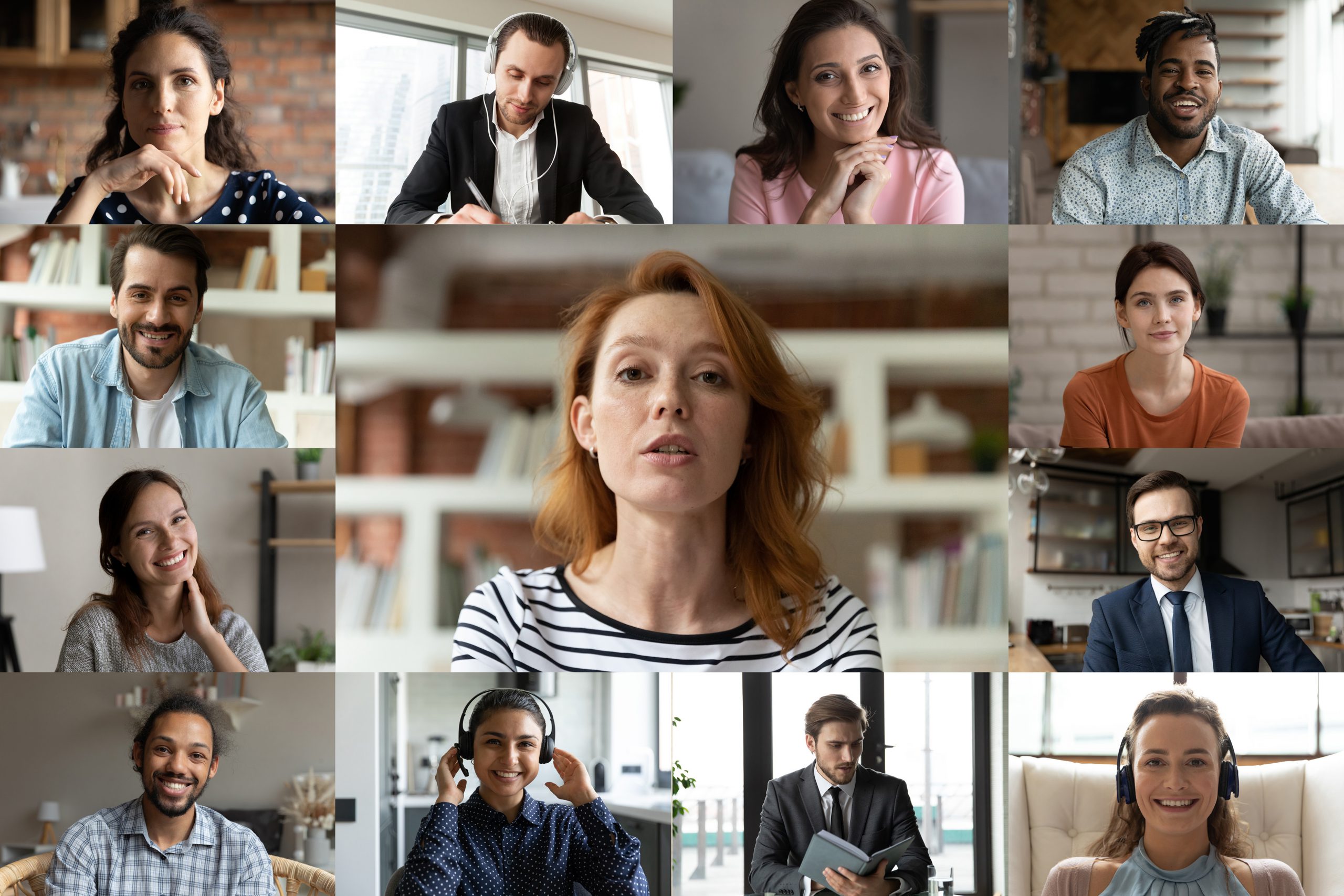 Focused young red-haired female employee leader holding video conference working call with happy diverse multiracial colleagues teammates, enjoying distant web brainstorming briefing meeting.